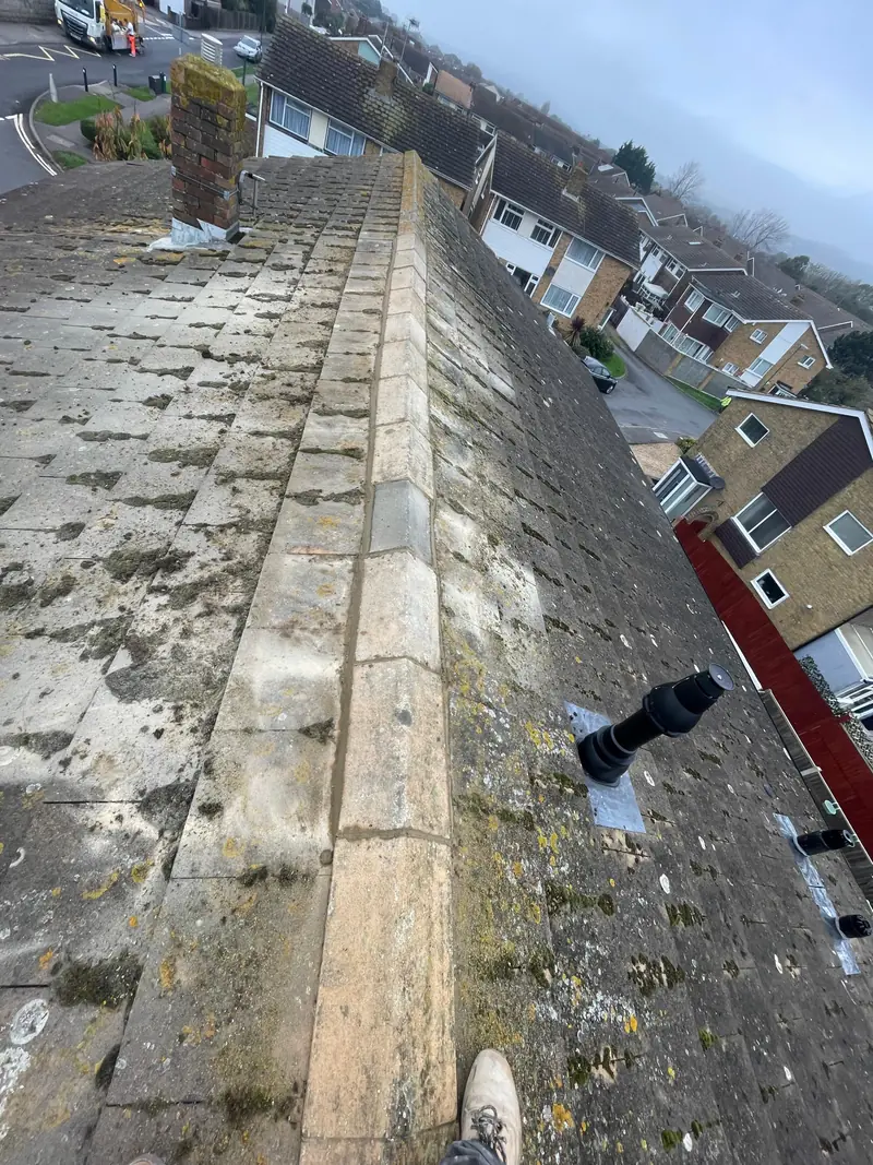Repointed roof ridge tiles with fresh mortar bedding